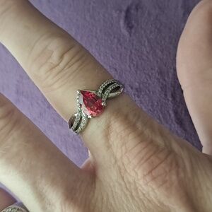 Padparadscha Sapphire & White Zircon Accented Triple Shank Ring.